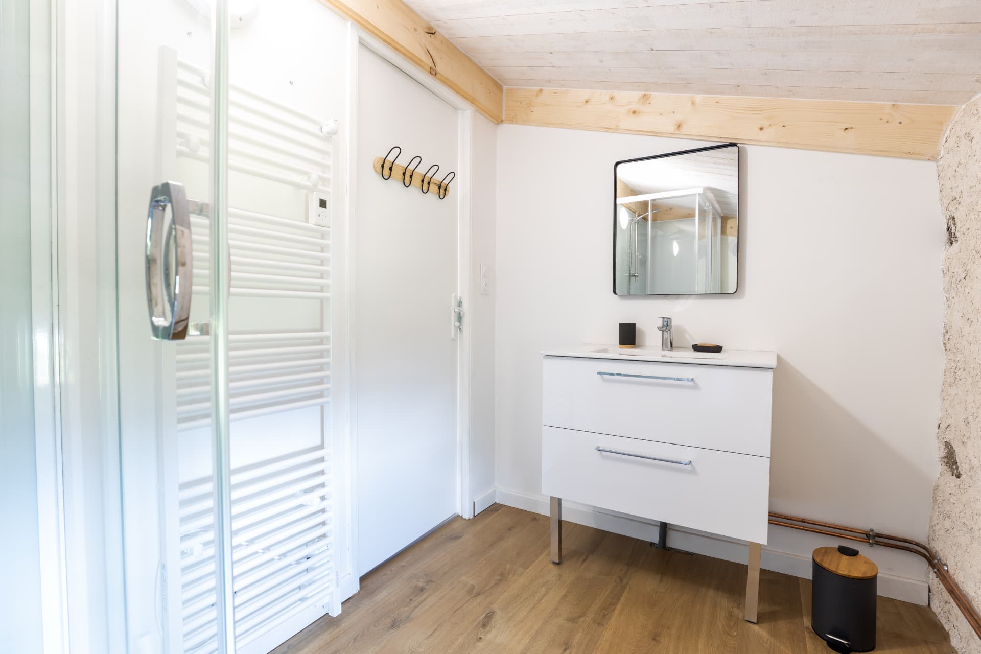 Salle de bain avec douche, vasque et sèche-serviettes